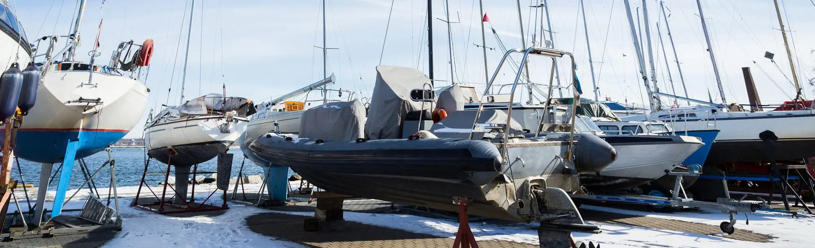 Marina scene with boats docked at a dock on a clear day